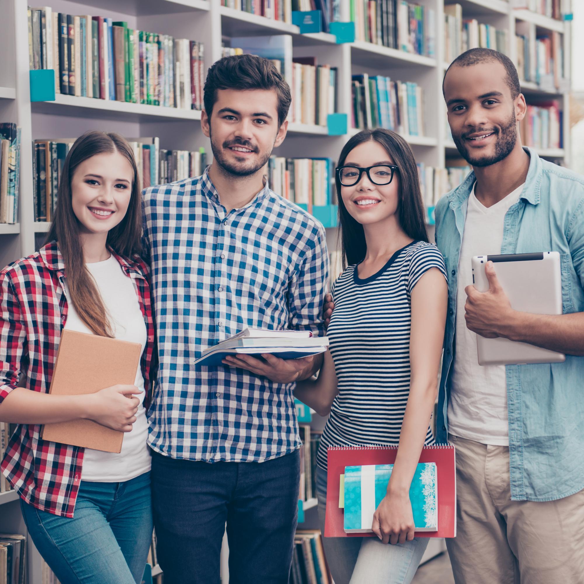 Two male and two female university students in a library