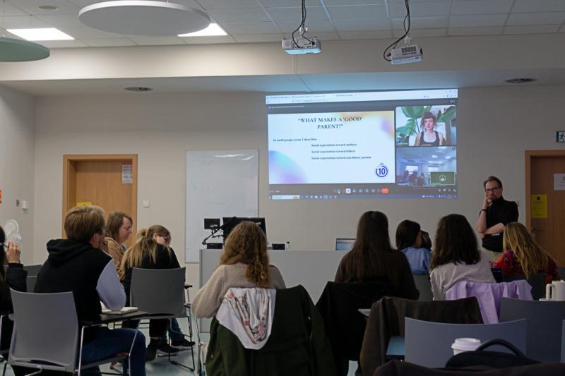 A group of university students listen to a lecture on parenting