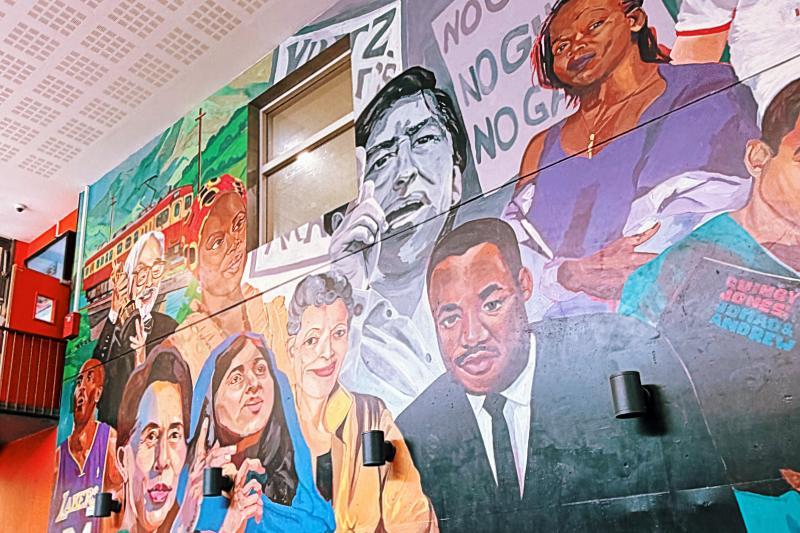 A mural in a cafe depicting political activists of different races
