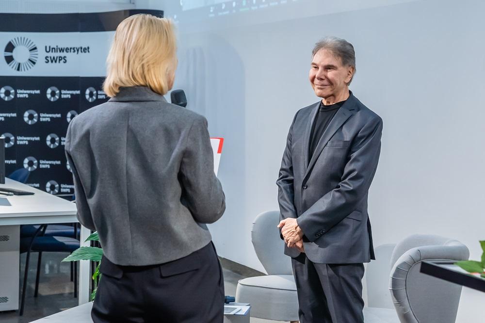 Smiling Professor Caldini waiting to receive the award
