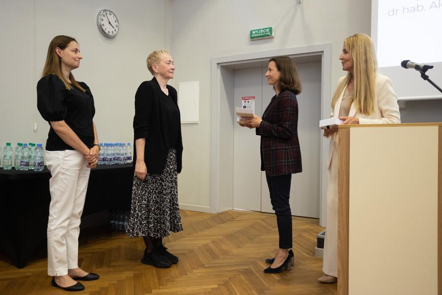 Professors Krystyna Drat-Ruszczak and Aleksandra Szymków-Sudziarska receiving "Medals of SWPS University" from the dean and vice-rector