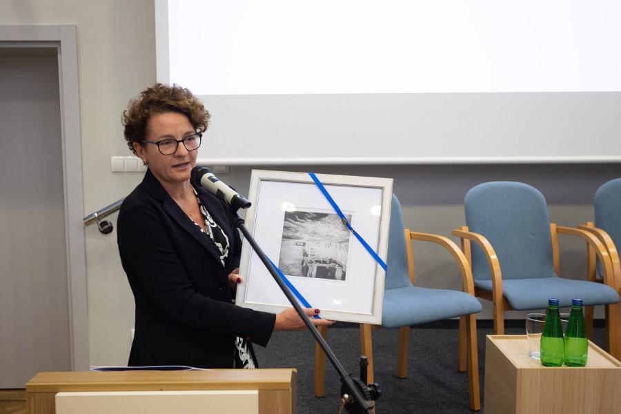 The Deputy Mayor of Sopot displays a framed picture of the Sopot pier