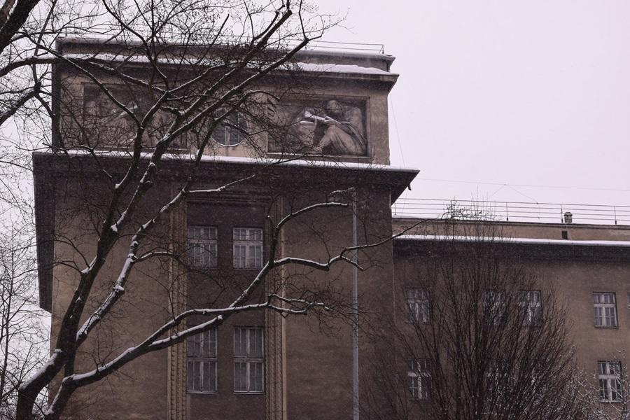 The exterior of the left wing of the building, featuring a bas-relief depicting an evangelist.