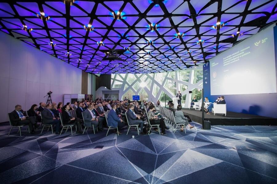 Full venue at LUMEN 2023 Conference; attendees listening to a panel discussion