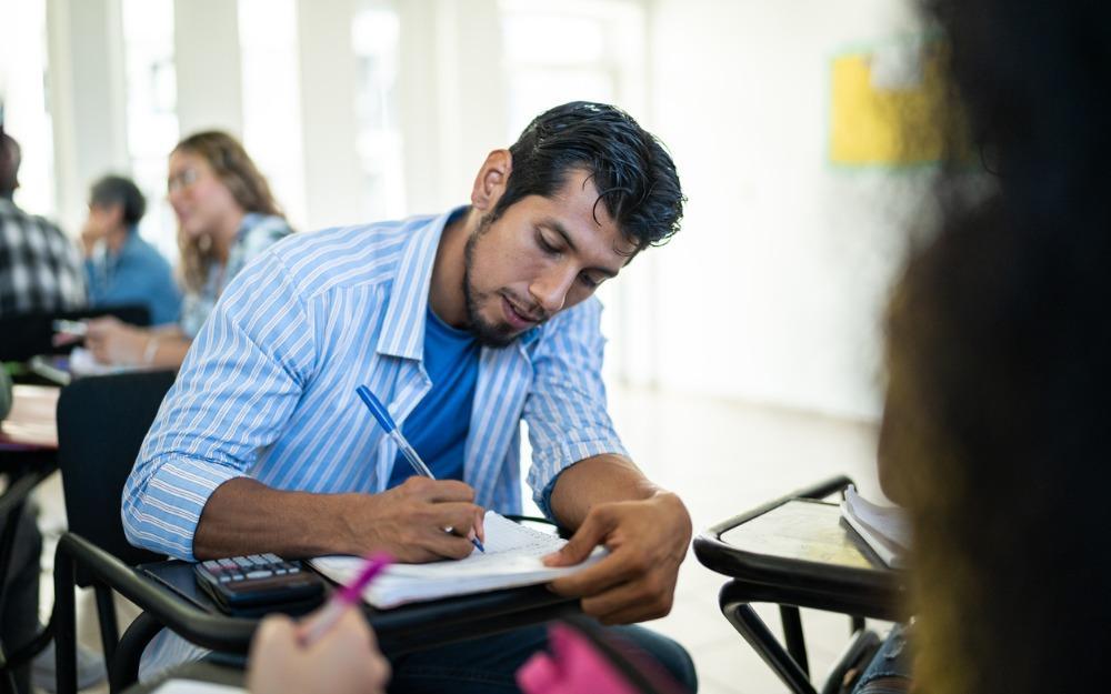adult_student_writing_at_chair-desk