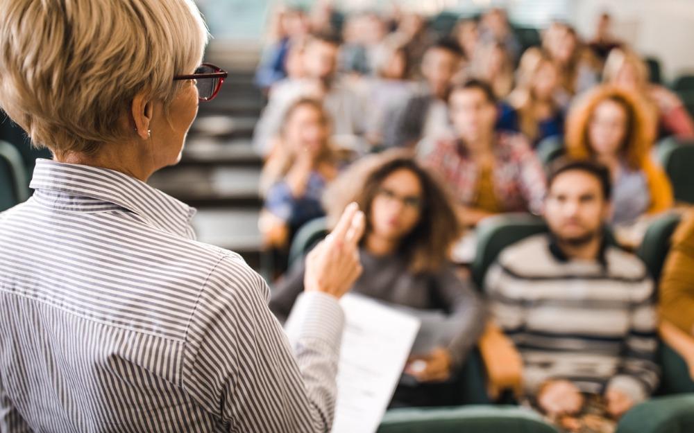 Female professor teaching classroom of students