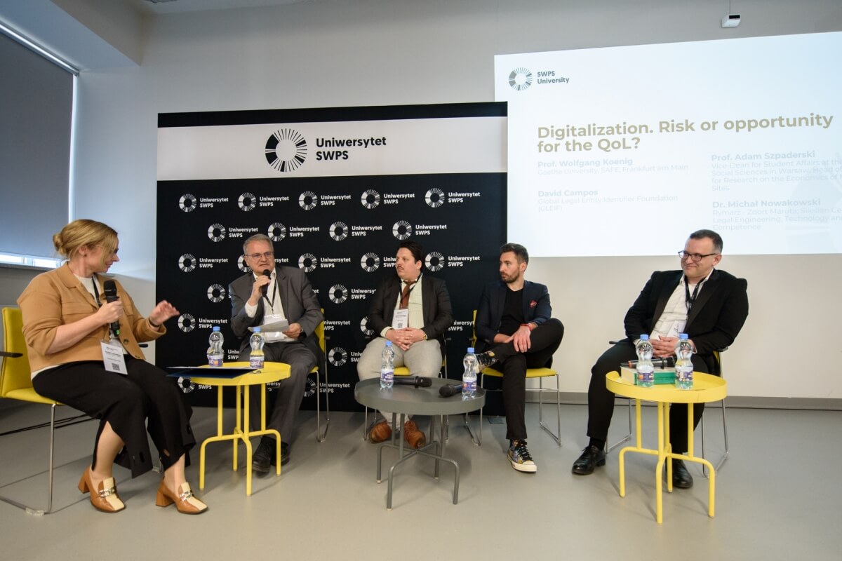 Speakers debating during a conference at SWPS University