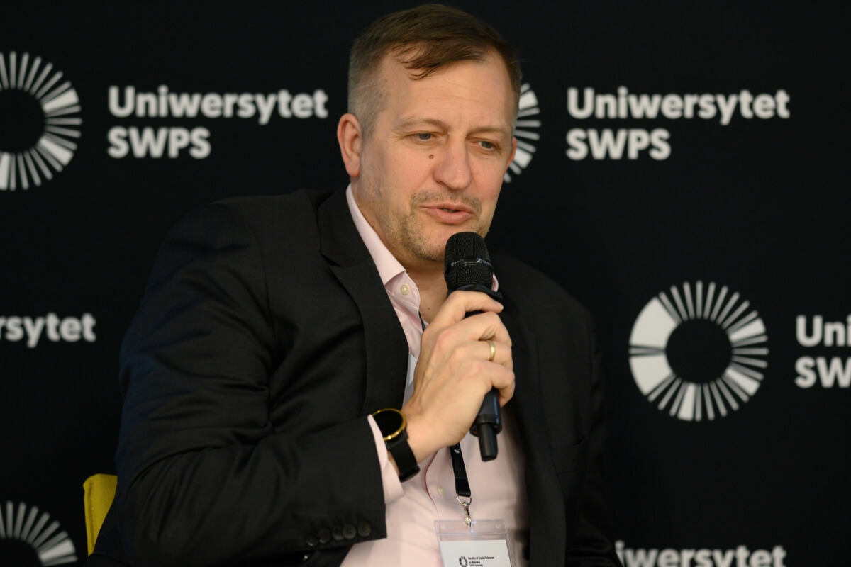 C. David DeBenedetti speaking at a conference on social innovation and quality of life at SWPS University