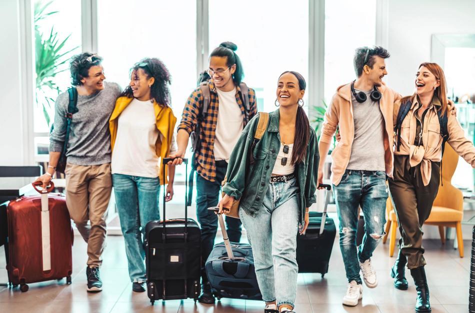 Group of young people at the airport ready to travel